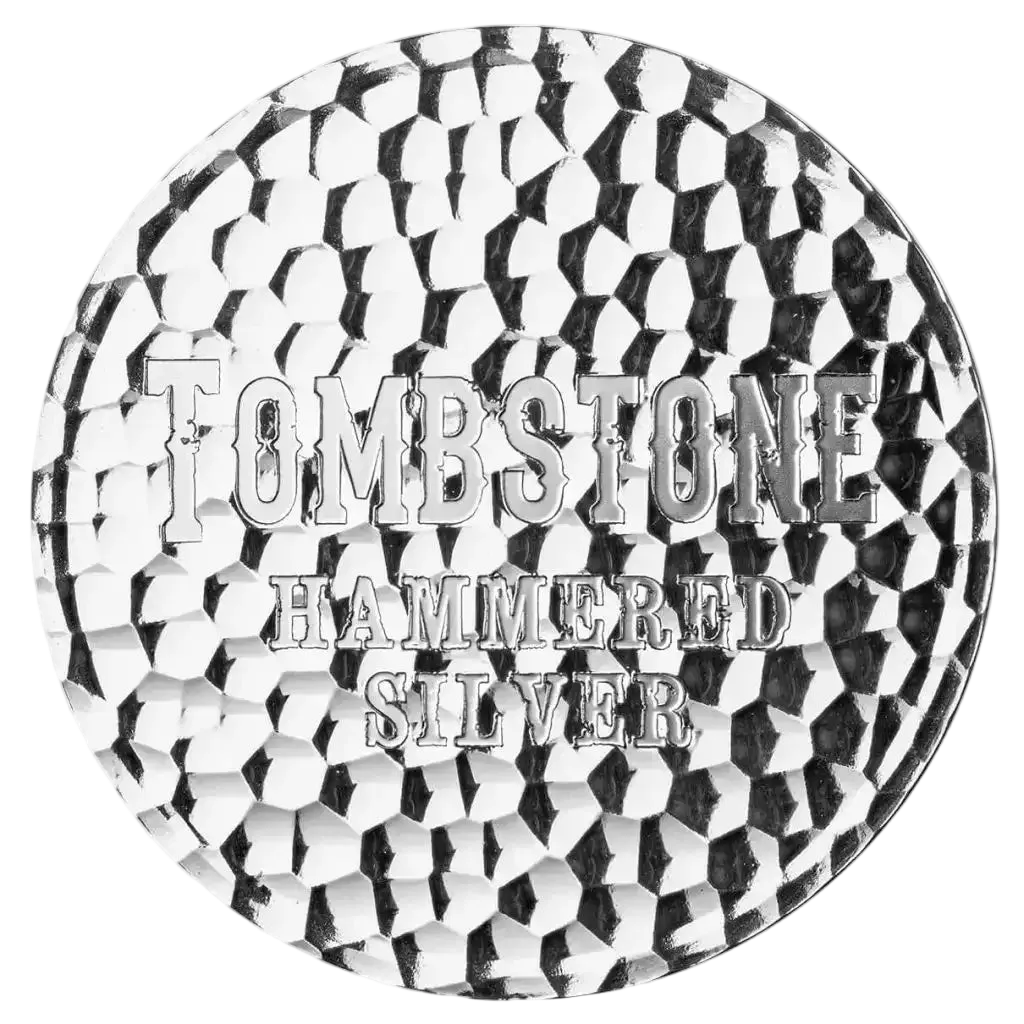 A circular silver-toned metal tin lid or decorative plate featuring a hammered, textured surface and embossed text reading 'TOMBSTONE HAMMERED SILVER' on a plain white background.